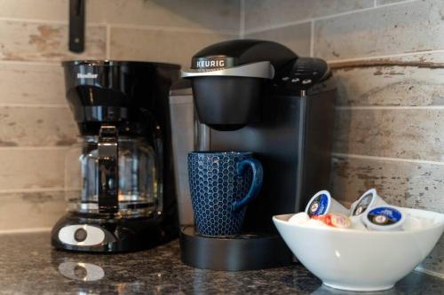 a kitchen counter with a coffee maker and a bowl of food at Perfectly located-Walk to bars- Close to Broadway in Nashville