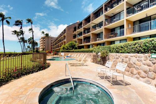 a swimming pool in front of a building at Maalaea Banyans 214 in Wailuku