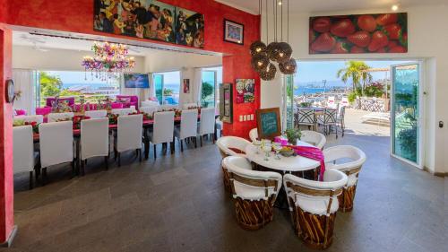a dining room with tables and chairs in a restaurant at Casa Ivonne in Puerto Vallarta