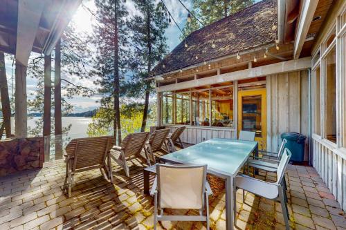 a patio with chairs and a table on a house at Hayden Lake Hideaway in Hayden Lake