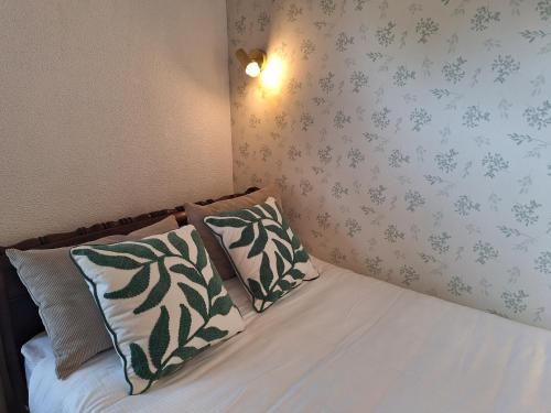a bedroom with a bed with two pillows on it at Casa de Cardido in Guimarães