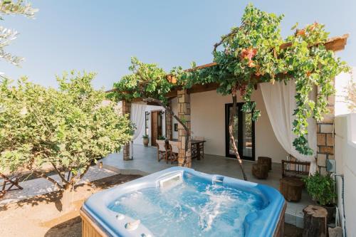 an outdoor hot tub in the backyard of a house at La Casetta della Nonna in Lardos