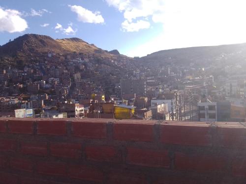 a view of a city with a mountain at killa andina inn in Puno