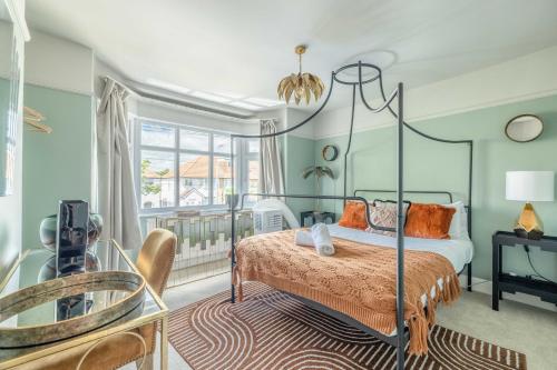 a bedroom with a canopy bed and a balcony at Super Cool Flats in Windsor with Parking and EV in Windsor