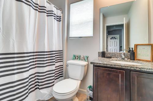 a bathroom with a toilet and a sink and a shower at Michigan Home with Yard, 3 Mi to Detroit Airport in Romulus