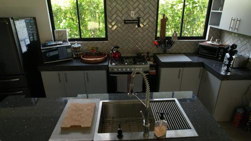 a kitchen with a sink and a stove at DreamHastHouse in Agua Azul