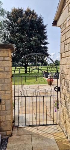 an iron gate with a park in the background at Stud House in Private Country Estate near Bruton in Gillingham