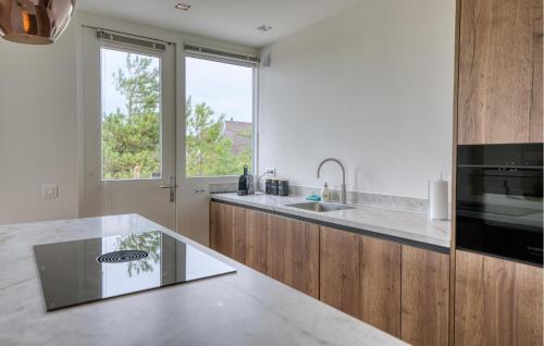 a kitchen with a sink and a counter top at Stunning Home In Bergen Aan Zee in Bergen aan Zee
