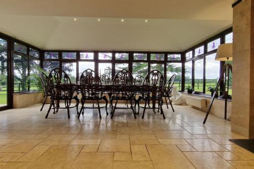a large dining room with a table and chairs at Stud House in Private Country Estate near Bruton in Gillingham