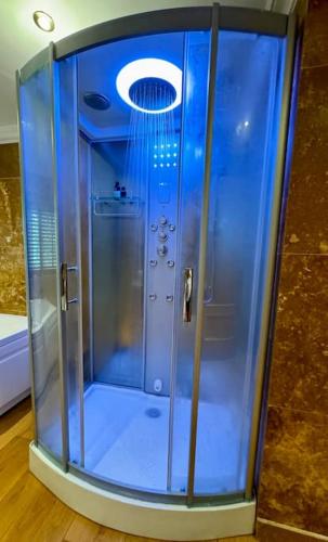a shower with a glass door in a room at Stud House in Private Country Estate near Bruton in Gillingham