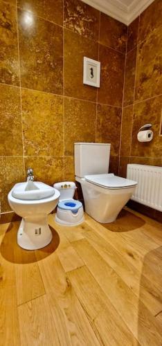 a bathroom with a toilet and a sink at Stud House in Private Country Estate near Bruton in Gillingham