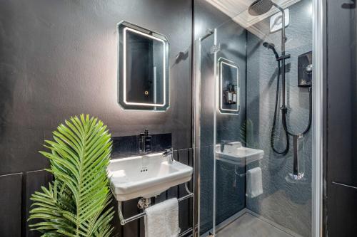 a bathroom with a sink and a shower at Super Cool Flats in Windsor with Parking and EV in Windsor