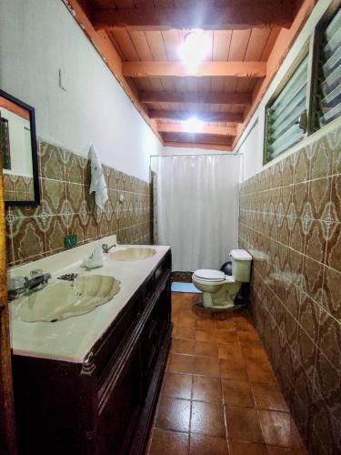a bathroom with two sinks and a toilet at CocoHouse Leon in León