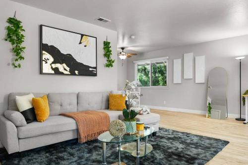 a living room with a couch and a table at Fully Furnished King Bed 1B1B by Tech Giants & Stanford Near SFO in San Mateo