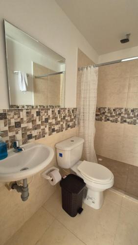 a bathroom with a white toilet and a sink at Apartamento Campestre 4 Piscinas, Jacuzzy y Sauna a 5m del Aeropuerto, 20m Parque del Cafe Ubicado en La Tebaida - F - by Molca Xperiences in Armenia