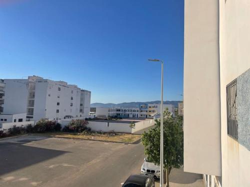 a view of a street in a city with buildings at Appart situé au centre de Martil ,moderne près de la plage ,de l'aéroport Tetouan et vue sur lac in Martil