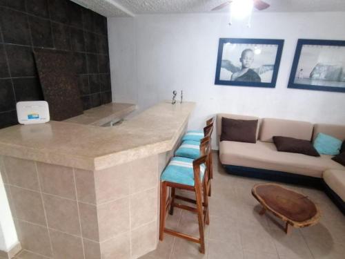 a living room with a bar and a couch at Casa Cayo in Ixtapa