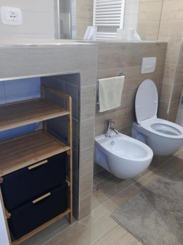 a bathroom with a toilet and a bidet and a sink at Maison Paola in Giulianova