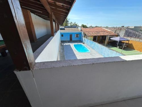 a view of a swimming pool from the balcony of a house at A Casa Azul in Peruíbe