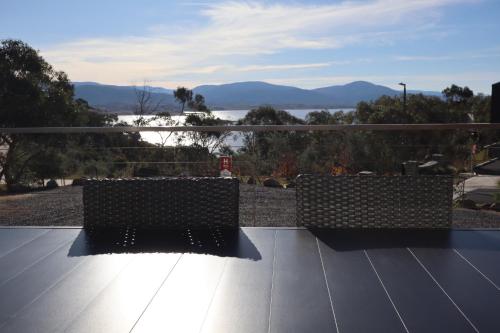 a couple of benches sitting on top of a roof at Hygge Eco Cabins Beautiful New Cabins with Amazing Views in Jindabyne