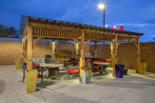 a wooden pavilion with tables and chairs in a patio at Best Western Plus Chandler Hotel & Suites in Chandler
