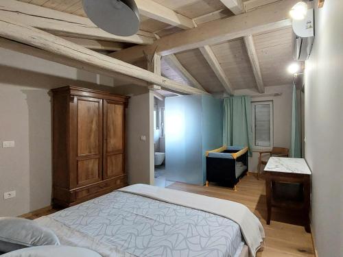 a bedroom with a bed and a desk in it at VILA ŠKARLANIJA, Umag in Umag