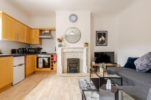 a living room with a couch and a fireplace at 5min to Huddersfield Royal Infirmary Hospital in Lindley