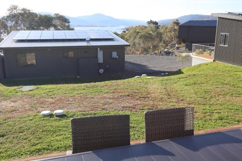 a view of a house with solar panels on the roof at Hygge Eco Cabins Beautiful New Cabins with Amazing Views in Jindabyne
