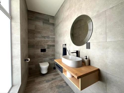 a bathroom with a sink and a mirror at Villa 206 Clarens Golf Estate in Clarens