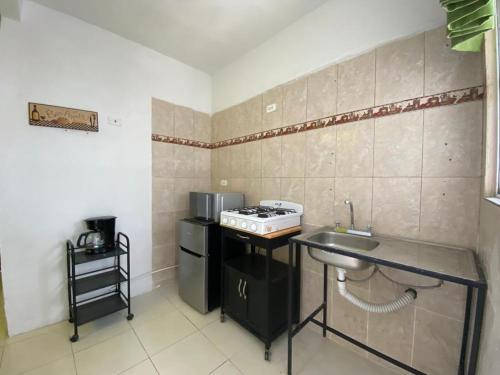 a small kitchen with a sink and a stove at Casa cerca del Aeropuerto in Monterrey