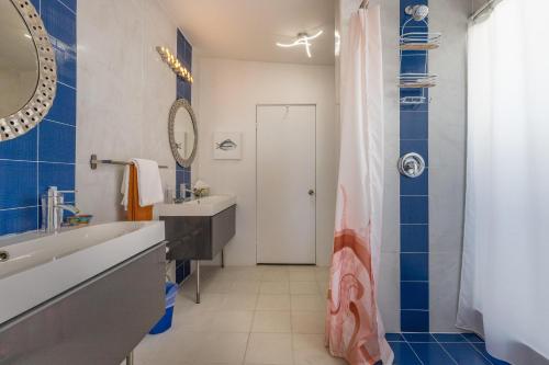 a bathroom with a tub and a sink and a mirror at La Perla in Playa Encanto