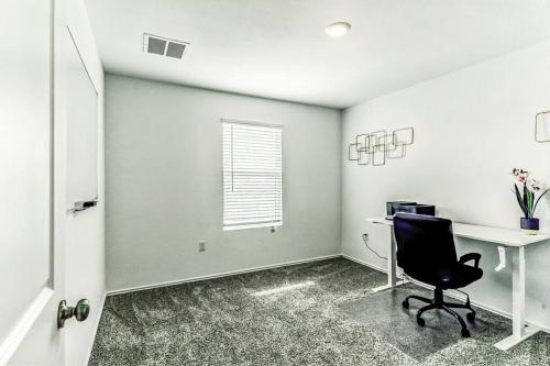 an office with a chair and a desk and a window at Entire house near airport & COTA in Del Valle