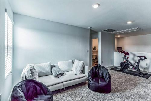 a living room with a couch and a bike at Entire house near airport & COTA in Del Valle