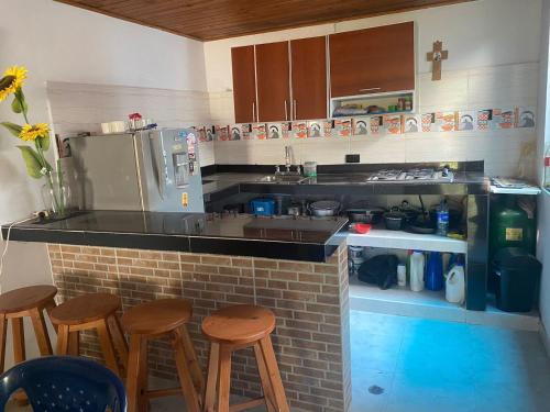 a kitchen with a counter with stools and a counter top at Chicala relax C4 in Girardot