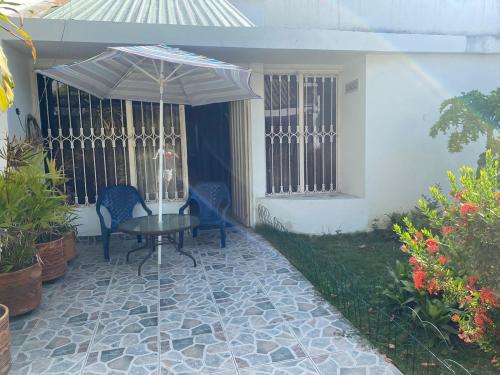 a patio with an umbrella and a table and chairs at Chicala relax C4 in Girardot