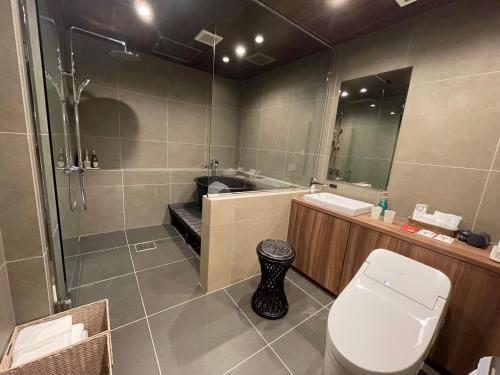 a bathroom with a toilet and a sink and a shower at Hotel Clio Court Hakata in Fukuoka