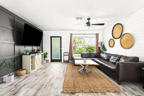 a living room with a black leather couch at October Special! Limited-time Discount Book Now! in Jupiter