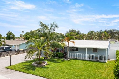 a house with palm trees in the yard at October Special! Limited-time Discount Book Now! in Jupiter
