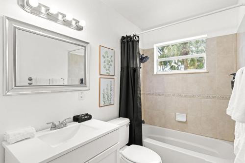 a bathroom with a sink and a toilet and a mirror at October Special! Limited-time Discount Book Now! in Jupiter