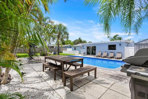 a backyard with a picnic table and a swimming pool at October Special! Limited-time Discount Book Now! in Jupiter