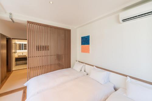 a living room with two white couches at Flower Base HIMAWARI in Fukuoka