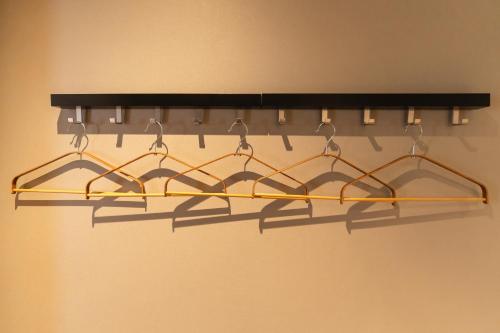 a black and gold chandelier hanging from a wall at Flower Base HIMAWARI in Fukuoka