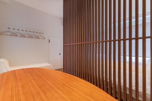 a wooden table in a room with a wooden fence at Flower Base HIMAWARI in Fukuoka