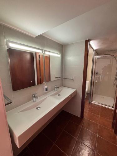 a bathroom with a sink and a mirror and a shower at Atlantic - Sea Front in Oia