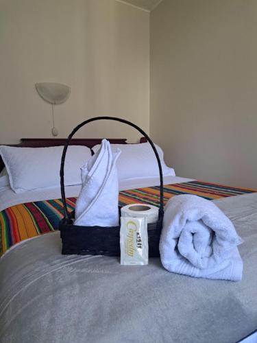 a hotel room with a bed with towels and a cup at Casa CarpeDM in Quito