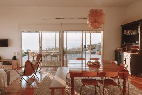 a dining room with a table and a view of the ocean at Sea Haven at Streaky Bay - A Secluded Beach Escape in Perlubie