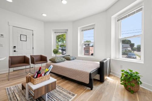 a bedroom with a bed and a couch and windows at 10Guests! Parking 1ST FLOOR-Duplex in Fair Lawn
