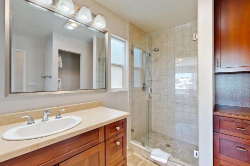 a bathroom with a sink and a shower at Newport Bay Front Vacation Home in Newport Beach