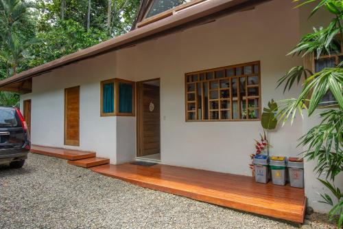 a house with a car parked in front of it at Casa Ambar in Puerto Viejo