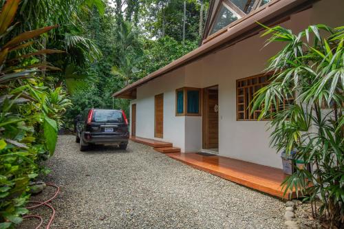 a car parked in front of a house at Casa Ambar in Puerto Viejo